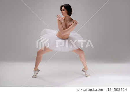 Woman in lingerie dances gracefully in ballet studio during a photo shoot 124502514