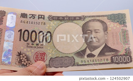 Close-up of a person holding the new 10,000 yen note Close-up of a person holding the new 10,000 yen note 124502907
