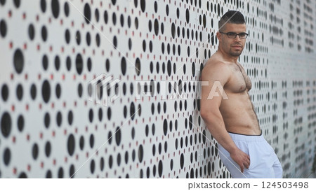 Muscular young man Arab posing against white background. Muscular young man Arab posing against white background. 124503498