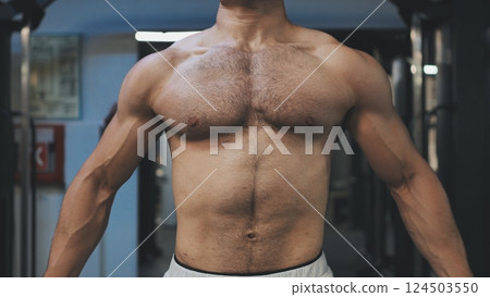 Muscular man workout in gym doing exercises for chest, cable crossover. Strong male naked torso abs. Muscular man workout in gym doing exercises for chest, cable crossover. Strong male naked torso abs. 124503550
