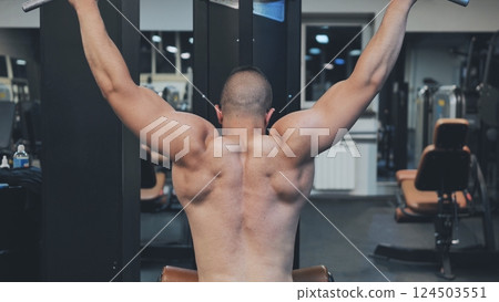 Back Workout Athlete muscular fitness male strong athletic man pumping up muscles workout bodybuilding muscular bodybuilder handsome men doing exercises in gym naked torso. 124503551