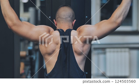 Back Workout Athlete muscular fitness male strong athletic man pumping up muscles workout bodybuilding muscular bodybuilder handsome men doing exercises in gym naked torso. Back Workout Athlete muscular fitness male strong athletic man pumping up muscles workout bodybuilding muscular bodybuilder handsome men doing exercises in gym naked torso. 124503560