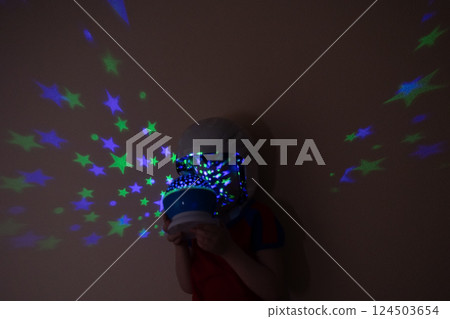 A child in an astronaut helmet watches the stars A child in an astronaut helmet watches the stars 124503654