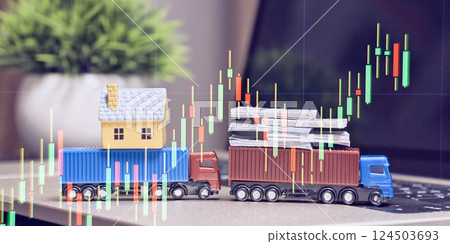 house and money stacks, with financial candlestick charts overlay, symbolizing logistics, real estate, and investment markets. 124503693