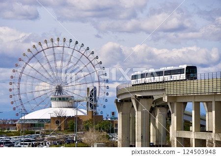 Linimo train running with Nagoya city in the background 124503948
