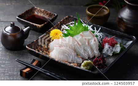 Sea bream sashimi: A dignified Japanese taste, with white fish sashimi and chopsticks 124503957