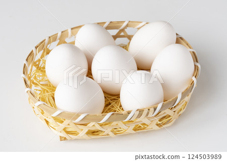 Raw eggs in a basket Raw eggs in a basket 124503989