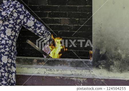 Vietnam, Hanoi, Woman burning Tran Quoc Pagoda banknotes 124504255