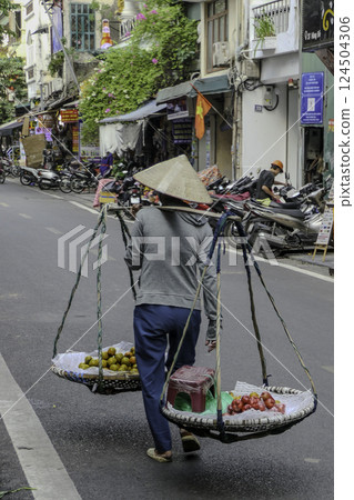 Hanoi, Vietnam, October 22, 2024. Scenes of daily life, peddler in the streets of Hanoi. Hanoi, Vietnam, October 22, 2024. Scenes of daily life, peddler in the streets of Hanoi. 124504306