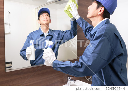 Male staff in work clothes cleaning the washroom 124504644