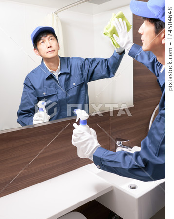 Male staff in work clothes cleaning the washroom 124504648