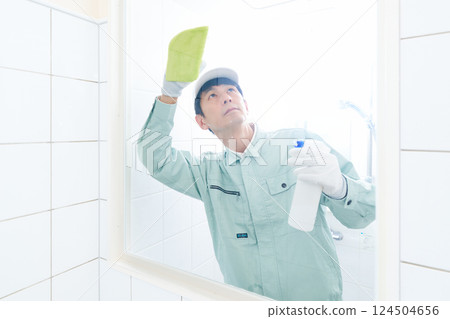 Male staff in work clothes cleaning the sanitary room 124504656