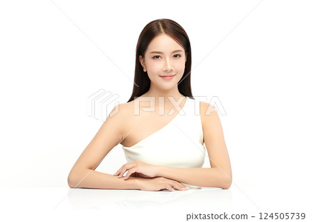A beautiful young Asian woman with clean, fresh skin against a white background. Skincare, facial treatment, cosmetology, beauty, and spa. An elegant portrait of an Asian woman. 124505739