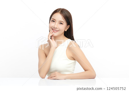 A beautiful young Asian woman with clean, fresh skin against a white background. Skincare, facial treatment, cosmetology, beauty, and spa. An elegant portrait of an Asian woman. A beautiful young Asian woman with clean, fresh skin against a white background. Skincare, facial treatment, cosmetology, beauty, and spa. An elegant portrait of an Asian woman. 124505752