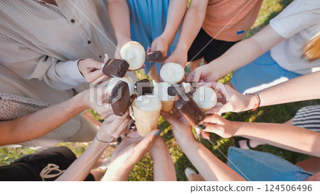 Friends from school enjoying sweet treats outdoors with ice cream cones and chocolate covered ice cream bars Friends from school enjoying sweet treats outdoors with ice cream cones and chocolate covered ice cream bars 124506496