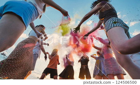 Young students celebrate end of school by throwing colored powder in the air Young students celebrate end of school by throwing colored powder in the air 124506500