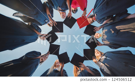 Graduates join their hats in a circle. Video in motion. 124506512