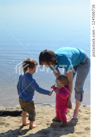 Family Moment by the Lake: Sharing and Bonding Family Moment by the Lake: Sharing and Bonding 124506716
