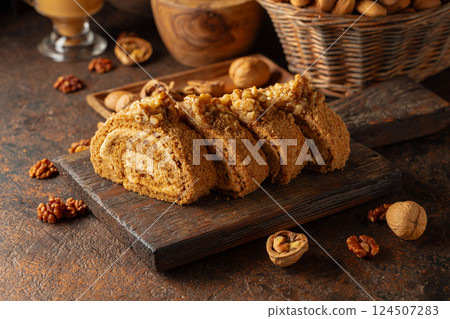 Walnut and buttercream roll: a traditional Oriental pastry. Walnut and buttercream roll: a traditional Oriental pastry. 124507283