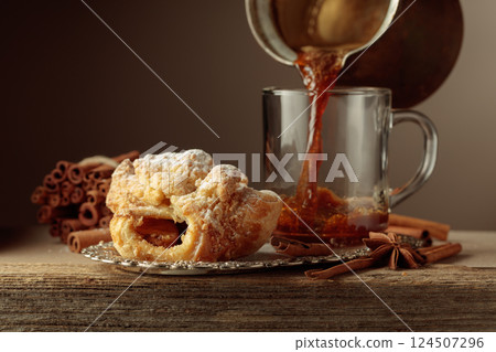 Viennese strudel and black coffee on an old wooden table. Viennese strudel and black coffee on an old wooden table. 124507296