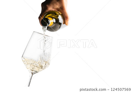 white wine being poured into wine glass on white background 124507569