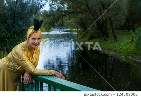 Beautiful girl wearing a turban and a stylized ethnic costume in the summer park Beautiful girl wearing a turban and a stylized ethnic costume in the summer park 124508006