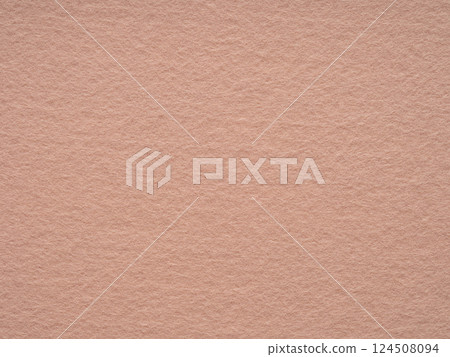 A serene blush felt canvas, radiating the soft glow of dawn, tender and inviting to the touch 124508094