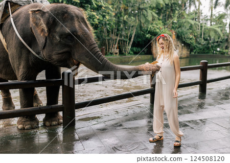 beautiful girl with smiling elephant, elephant village, bali 124508120