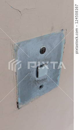 steel lift button over the vintage concrete wall. industrial concept 124508167