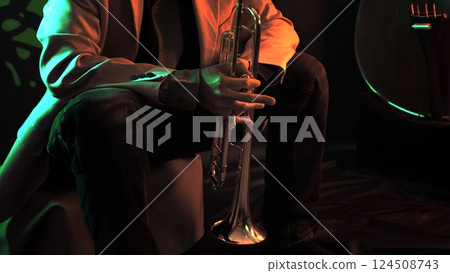 Man sitting with a trumpet 124508743