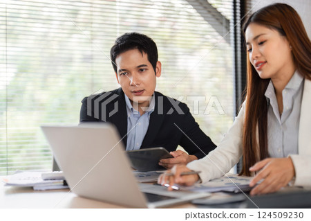 Focused Collaboration and Analysis. Two professionals deeply engaged in reviewing project data. Focused Collaboration and Analysis. Two professionals deeply engaged in reviewing project data. 124509230