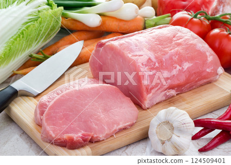 Vegetables and pork meat on cutting board 124509401