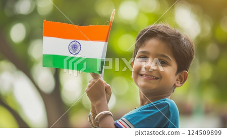 Happy Child Holding Indian Flag During National Celebration Happy Child Holding Indian Flag During National Celebration 124509899