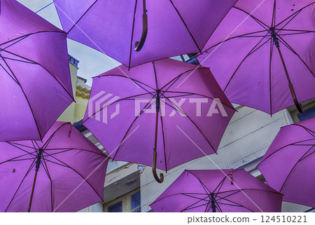 Pink umbrellas decorating the streets of Grasse, Cote d'Azur, France Pink umbrellas decorating the streets of Grasse, Cote d'Azur, France 124510221