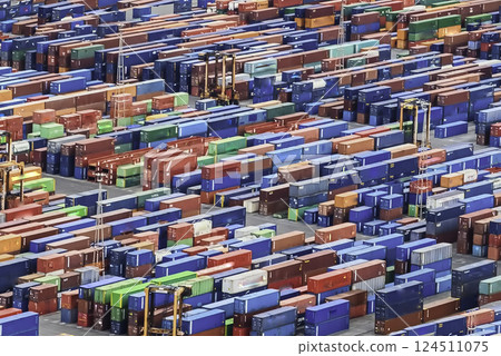 Aerial view over shipping containers stacked on a commercial port Aerial view over shipping containers stacked on a commercial port 124511075
