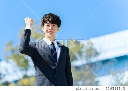 Businessman, blue sky, fist pump 124511143