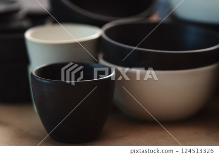 Matt ceramic handmade tableware in a workshop closeup 124513326