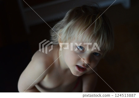 Curious Child with Blonde Hair Looking Upward 124513887