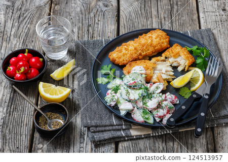 fried battered fish fillets with radish dill salad 124513957