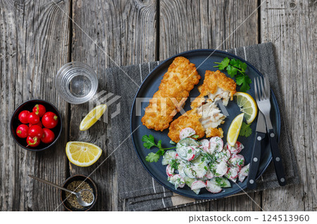 fried battered fish fillets with radish dill salad 124513960
