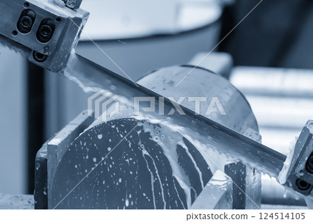 The band saw cutting machine cutting the metal shaft parts with coolant method. The band saw cutting machine cutting the metal shaft parts with coolant method. 124514105