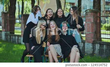 High school students having a great time together outdoors on school grounds 124514752