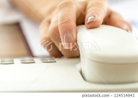 Closeup of female hand answering a call 124514941