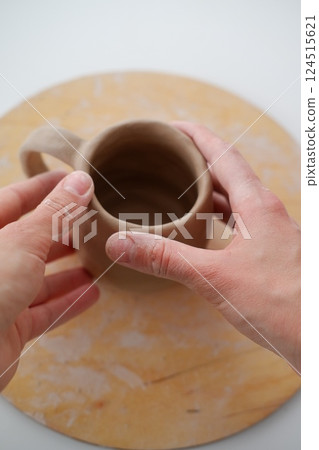 Making pottery from clay, handicraft, clay modeling, master's hands 124515621