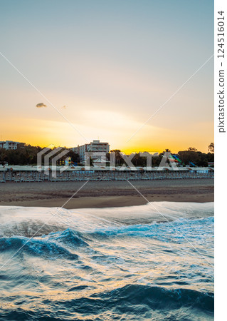 Mediterranean azure sea at dawn. Sandy beach at dawn. Turkey, Hotel territory. 124516014