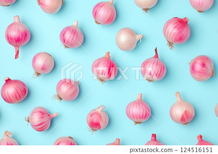 Fresh red onions are placed in an even pattern on a pastel blue background, forming a visually appealing flat lay Fresh red onions are placed in an even pattern on a pastel blue background, forming a visually appealing flat lay 124516151