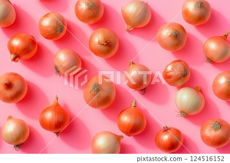 Golden onions are scattered on a pastel pink background with long shadows, creating a warm and stylish composition Golden onions are scattered on a pastel pink background with long shadows, creating a warm and stylish composition 124516152