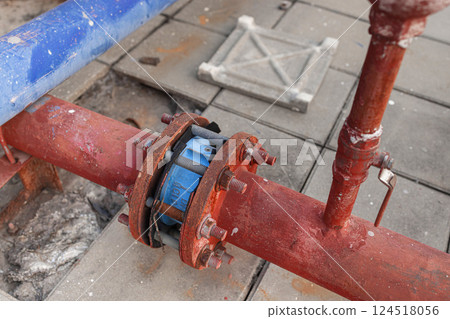 old grunge outdoor water connection pipe watering system connecting together rusty grungy weathered 124518056