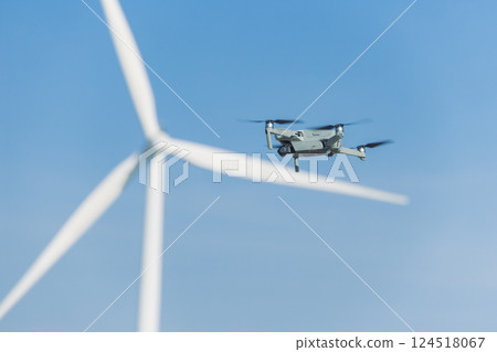 Engineer using drone technology device to survey service maintenance wind turbine power station 124518067