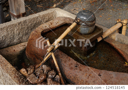 Temizuya water pavilion, Japan Shrine Temple Front Yard Fountain and Stone Bowl for hand cleaning. 124518145